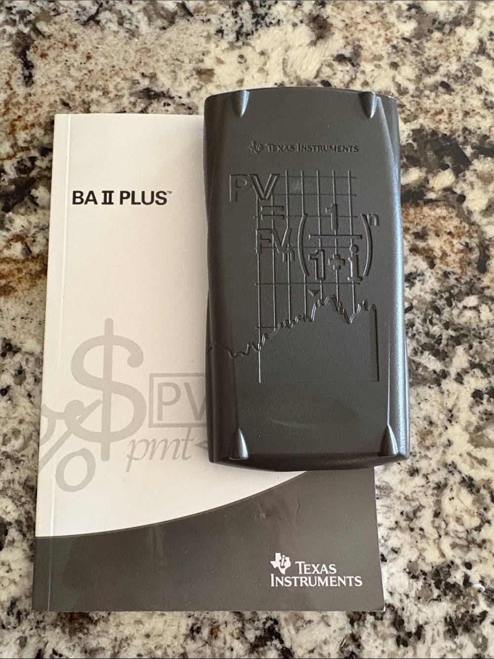 Texas Instruments BA II Plus Calculator with cover and book
